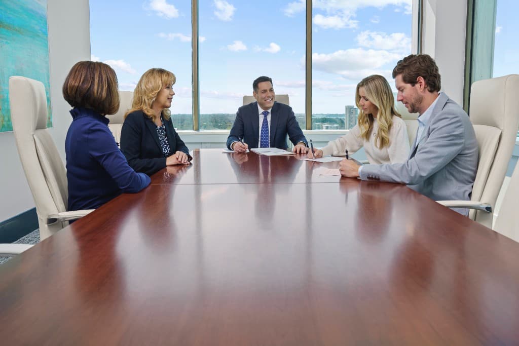 Michael Infanti meeting with clients around a conference table